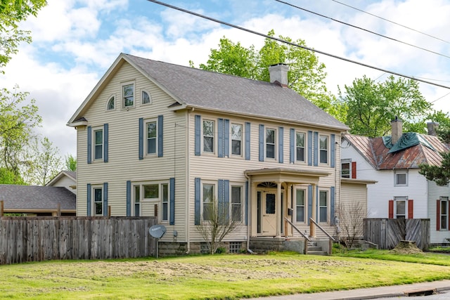 colonial-style house with a chimney
