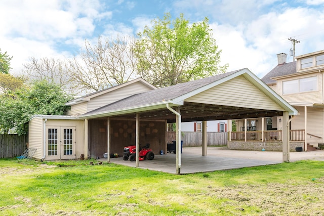 rear view of property featuring french doors and a carport