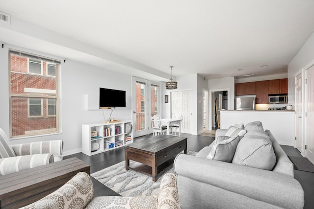 living area with dark wood-style floors and baseboards