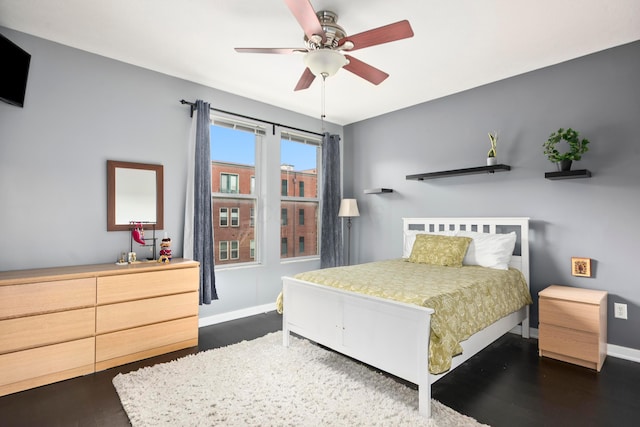 bedroom with dark wood-style flooring and baseboards