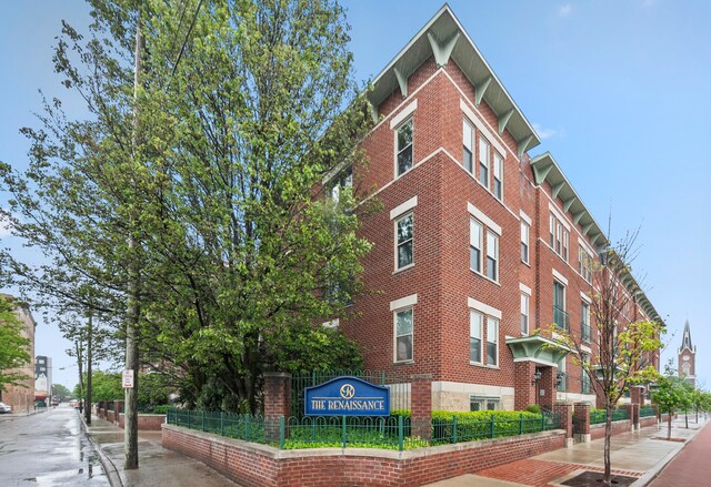 view of building exterior featuring fence