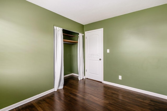 1825 Ormond Ave, Columbus, OH 43224 - unfurnished bedroom with baseboards, dark wood-style floors, and a closet
