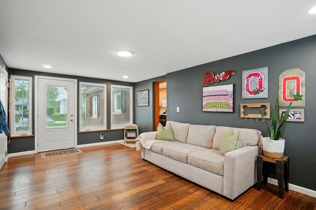 living room featuring baseboards, hardwood / wood-style floors, and recessed lighting