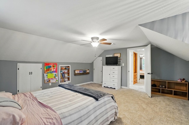 bedroom with light colored carpet, lofted ceiling, and a ceiling fan