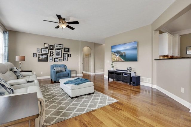 4919 Nadine Park Dr, Hilliard, OH 43026 - living area featuring arched walkways, a ceiling fan, light wood-type flooring, and baseboards
