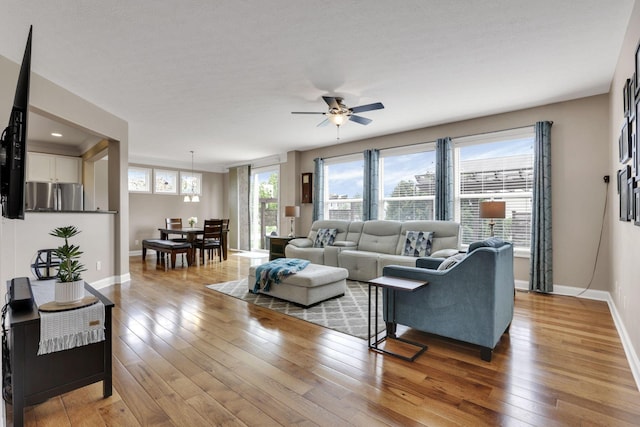 4919 Nadine Park Dr, Hilliard, OH 43026 - living area featuring a ceiling fan, light wood finished floors, and baseboards