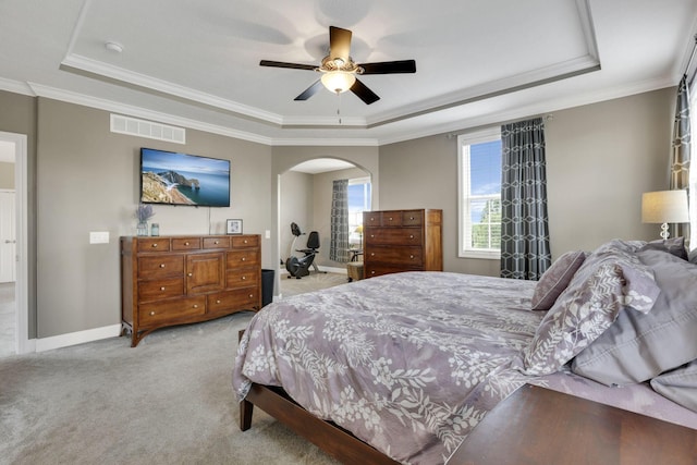 4919 Nadine Park Dr, Hilliard, OH 43026 - bedroom with a tray ceiling, light carpet, arched walkways, baseboards, and crown molding