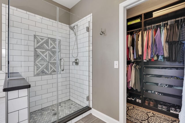 4919 Nadine Park Dr, Hilliard, OH 43026 - full bath with a stall shower, a spacious closet, tile patterned floors, and baseboards