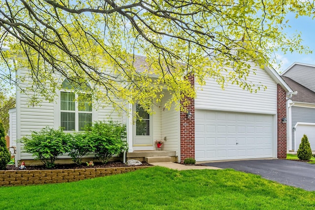 119 Harvard Loop, Delaware, OH 43015 - view of front facade featuring asphalt driveway, a front yard, a garage, and entry steps