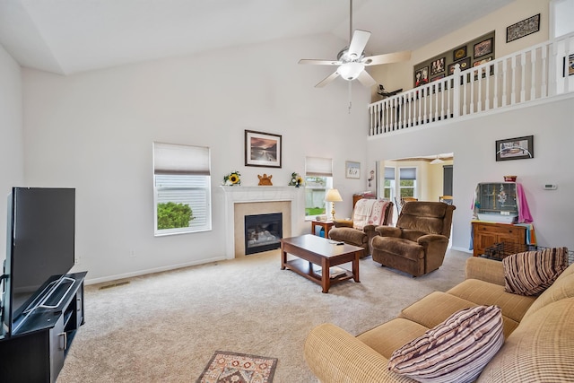 119 Harvard Loop, Delaware, OH 43015 - carpeted living area featuring ceiling fan, a glass covered fireplace, high vaulted ceiling, and baseboards