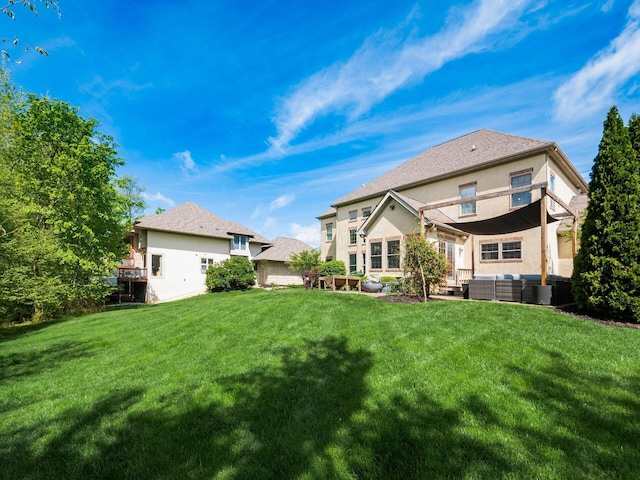 9378 Pine Creek Dr, Powell, OH 43065 - back of house with an outdoor hangout area, stucco siding, and a lawn