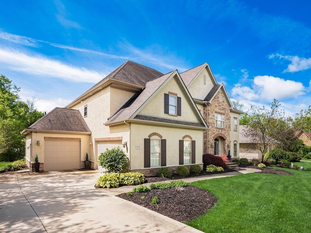 9378 Pine Creek Dr, Powell, OH 43065 - french country home featuring stucco siding, concrete driveway, a front lawn, and stone siding