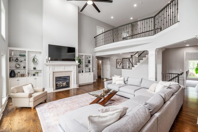 9378 Pine Creek Dr, Powell, OH 43065 - living area with a towering ceiling, ceiling fan, wood finished floors, a premium fireplace, and recessed lighting