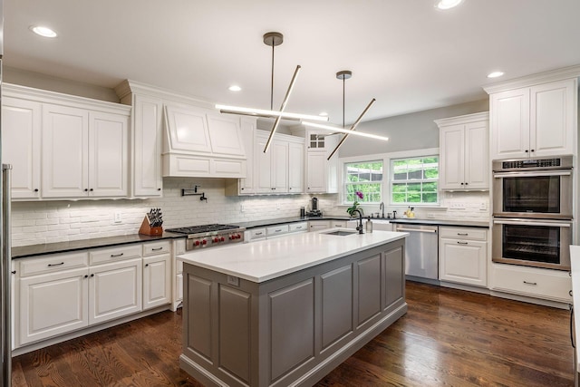 9378 Pine Creek Dr, Powell, OH 43065 - kitchen with stainless steel appliances, a sink, white cabinets, decorative backsplash, and recessed lighting