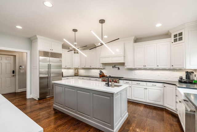 9378 Pine Creek Dr, Powell, OH 43065 - kitchen with stainless steel appliances, a sink, a center island, white cabinetry, and recessed lighting