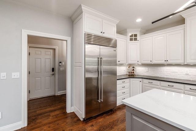 9378 Pine Creek Dr, Powell, OH 43065 - kitchen featuring built in fridge, tasteful backsplash, white cabinetry, dark wood-style flooring, and recessed lighting