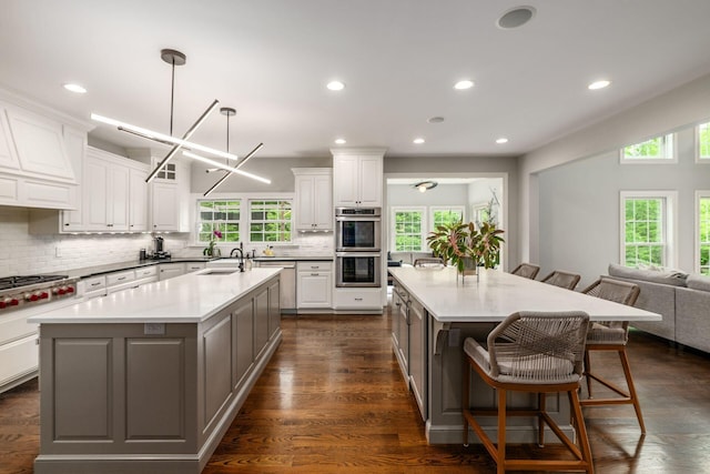 9378 Pine Creek Dr, Powell, OH 43065 - kitchen with an island with sink, appliances with stainless steel finishes, healthy amount of natural light, and recessed lighting