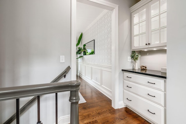 9378 Pine Creek Dr, Powell, OH 43065 - hall with crown molding, dark wood-style floors, wainscoting, a decorative wall, and wallpapered walls