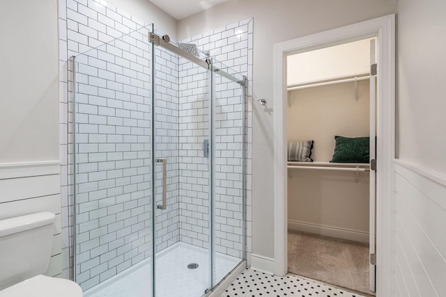 9378 Pine Creek Dr, Powell, OH 43065 - bathroom featuring a stall shower, toilet, and wainscoting