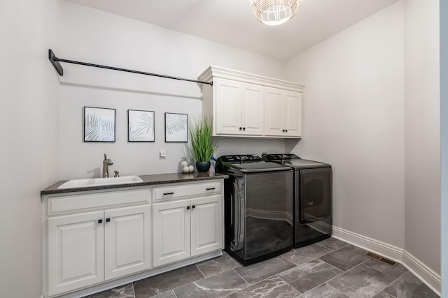 9378 Pine Creek Dr, Powell, OH 43065 - clothes washing area featuring washer and clothes dryer, cabinet space, baseboards, and dark marble finish floors