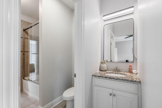 9378 Pine Creek Dr, Powell, OH 43065 - full bath featuring vanity, toilet, tile patterned flooring, combined bath / shower with glass door, and baseboards