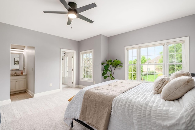 9378 Pine Creek Dr, Powell, OH 43065 - bedroom featuring baseboards, light colored carpet, ensuite bathroom, and a sink