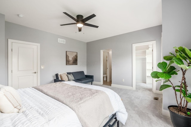 9378 Pine Creek Dr, Powell, OH 43065 - bedroom with a walk in closet, light colored carpet, a closet, baseboards, and a ceiling fan