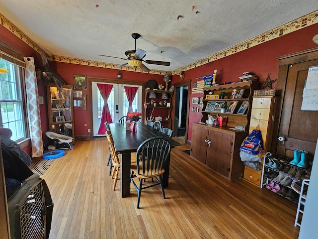 dining room with a textured ceiling, hardwood / wood-style floors, and ceiling fan