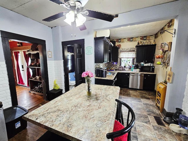 kitchen with black microwave, stainless steel dishwasher, dark cabinetry, and a ceiling fan