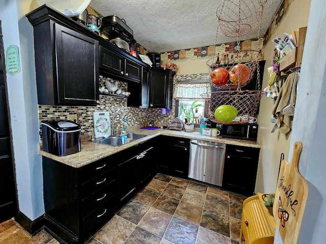 kitchen with dark cabinetry, dishwasher, black microwave, a sink, and light countertops