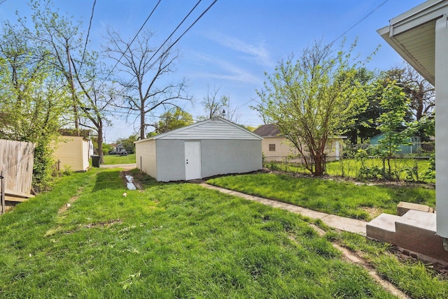 view of yard featuring a storage shed and an outbuilding
