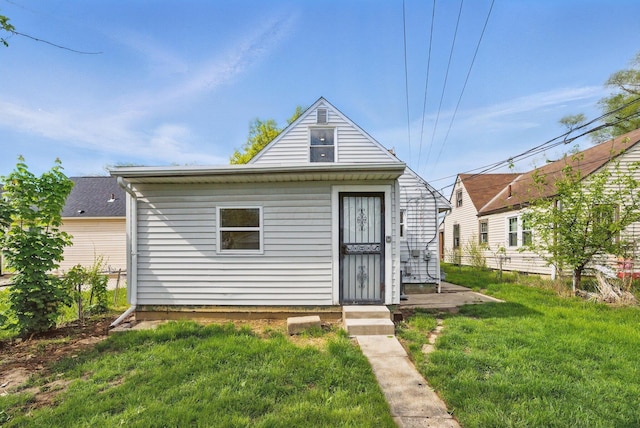 back of property featuring a yard
