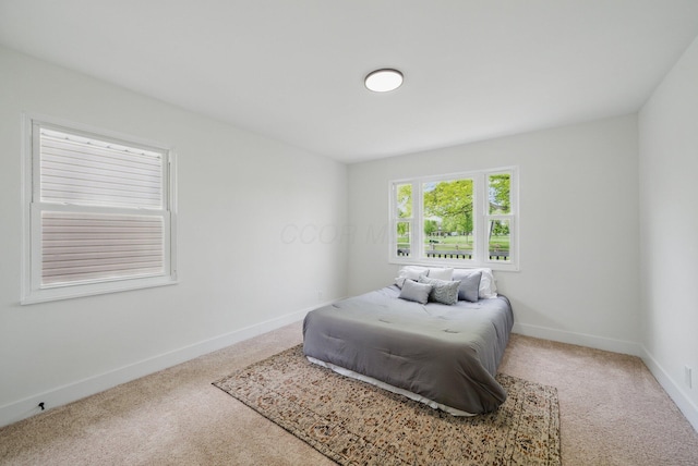 carpeted bedroom featuring baseboards