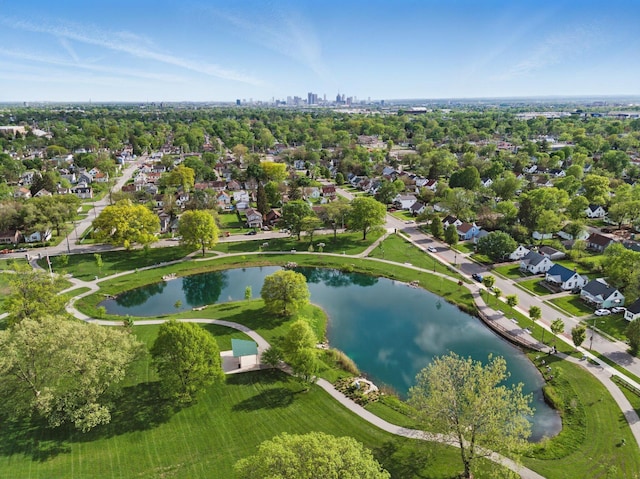 aerial view of property and surrounding area with a nearby body of water and nearby suburban area