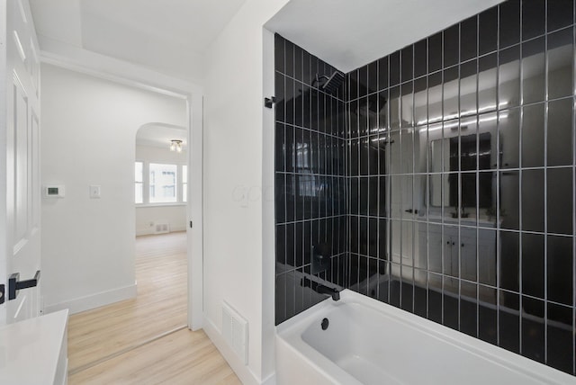 full bathroom featuring wood finished floors, shower / bath combination, and baseboards