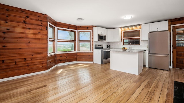 255 S Preston St, Centerburg, OH 43011 - kitchen with stainless steel appliances, light wood-style flooring, white cabinetry, and a kitchen island