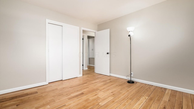 255 S Preston St, Centerburg, OH 43011 - unfurnished bedroom with light wood finished floors, baseboards, and a closet