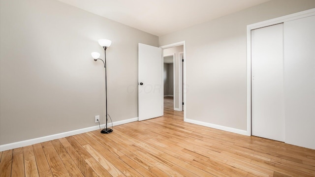 255 S Preston St, Centerburg, OH 43011 - unfurnished bedroom with hardwood / wood-style floors, a closet, and baseboards