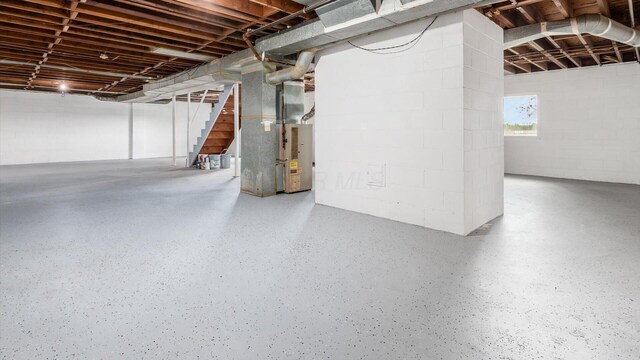 255 S Preston St, Centerburg, OH 43011 - basement featuring stairs, concrete block wall, and heating unit