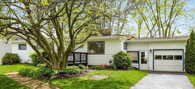 255 S Preston St, Centerburg, OH 43011 - view of front facade with an attached garage, asphalt driveway, a front yard, and a chimney