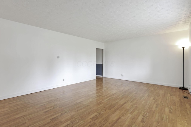315 Redmond Rd, Columbus, OH 43228 - spare room featuring wood finished floors, a textured ceiling, and baseboards