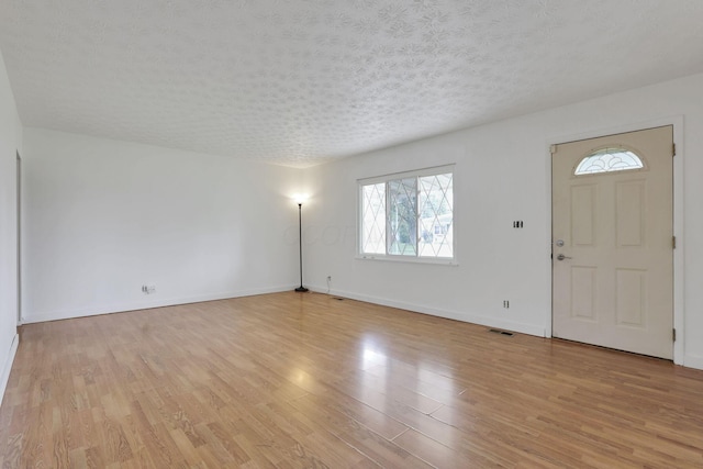 315 Redmond Rd, Columbus, OH 43228 - entrance foyer with healthy amount of natural light, light wood finished floors, baseboards, and a textured ceiling