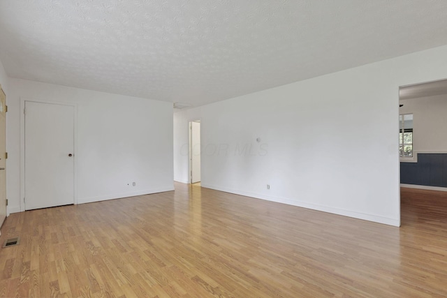 315 Redmond Rd, Columbus, OH 43228 - spare room with light wood-style floors, a textured ceiling, and baseboards