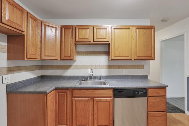 315 Redmond Rd, Columbus, OH 43228 - kitchen featuring stainless steel dishwasher, a sink, dark countertops, and backsplash