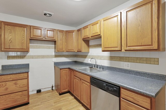 315 Redmond Rd, Columbus, OH 43228 - kitchen featuring a sink, stainless steel dishwasher, tasteful backsplash, light wood-style floors, and dark countertops