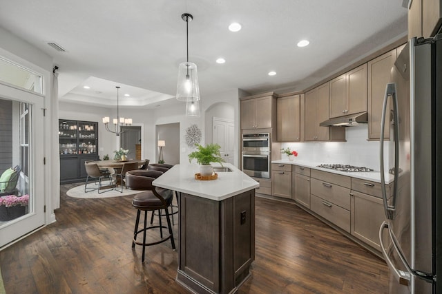 6678 Trinity Mist Way, Delaware, OH 43015 - kitchen featuring stainless steel appliances, under cabinet range hood, recessed lighting, backsplash, and light countertops