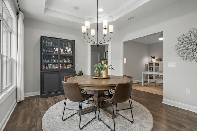 6678 Trinity Mist Way, Delaware, OH 43015 - dining space with a tray ceiling, dark wood finished floors, a chandelier, crown molding, and baseboards