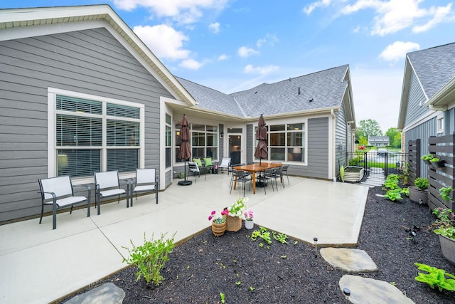 6678 Trinity Mist Way, Delaware, OH 43015 - rear view of house with fence, a patio area, and roof with shingles