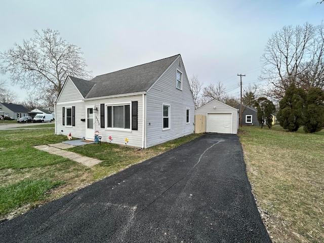 2322 Mecca Rd, Columbus, OH 43224 - view of front of property with a shingled roof, an outbuilding, a garage, driveway, and a front yard