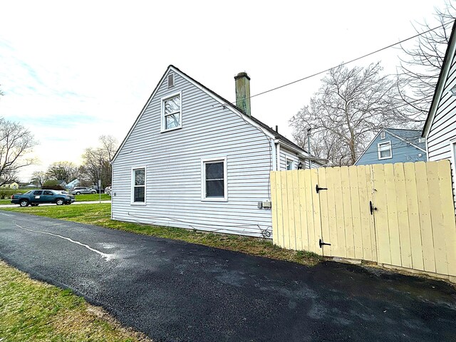 2322 Mecca Rd, Columbus, OH 43224 - view of property exterior with a chimney and fence